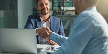 Shot of two businessmen shaking hands in an office  Our Services HR recruitments 360x180